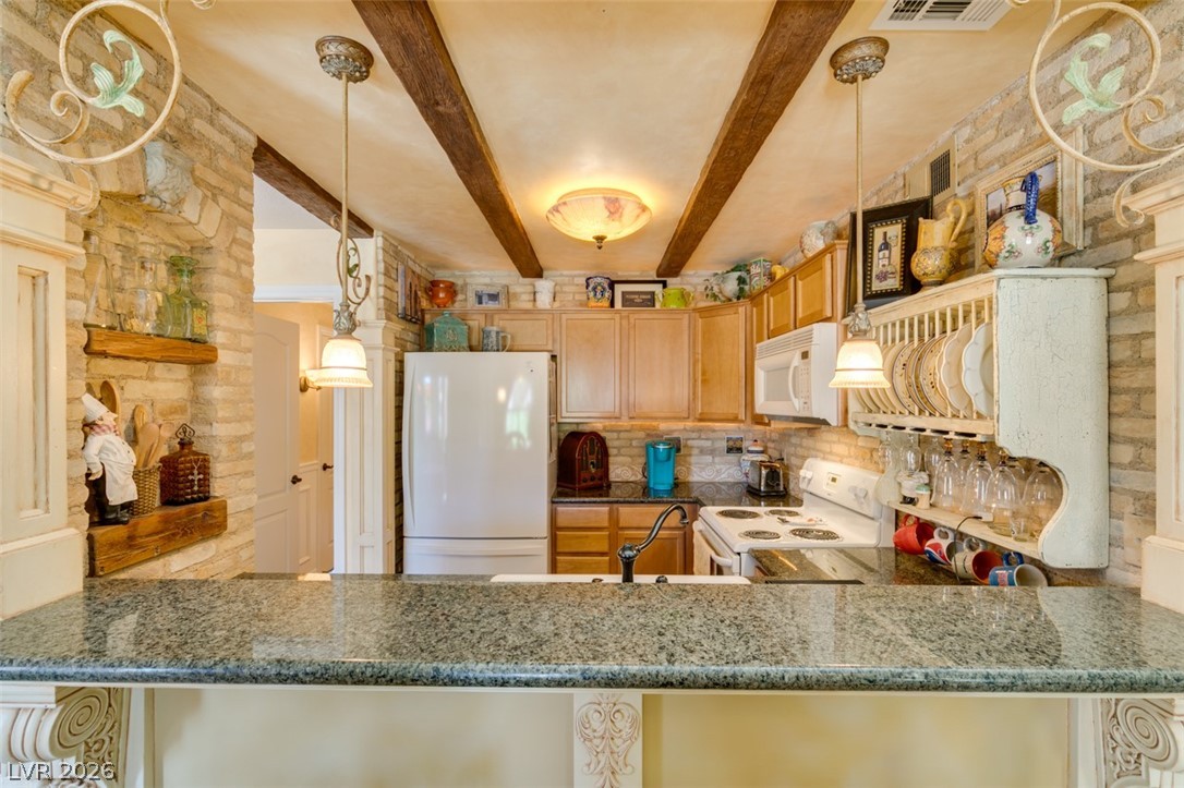 9325 West Desert Inn Road, Unit 244 Las Vegas, NV 89117 - Photo 21 of 55 A charming kitchen showcases rustic ceiling beams, granite counters, and a unique brick accent wall.