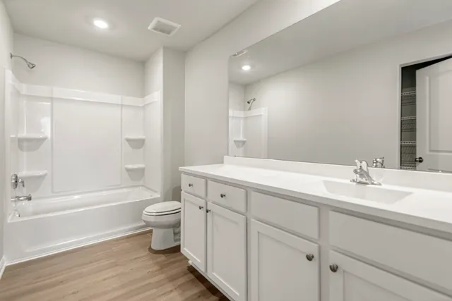 a white bath tub sitting next to a white sink