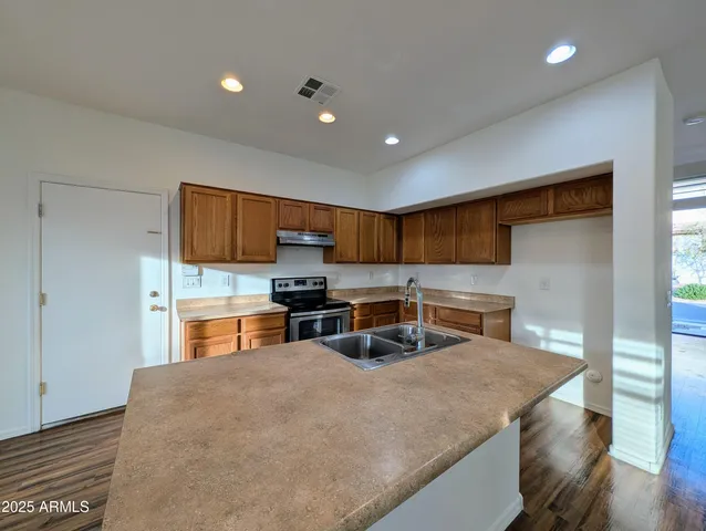 a kitchen that has a sink and a stove in it