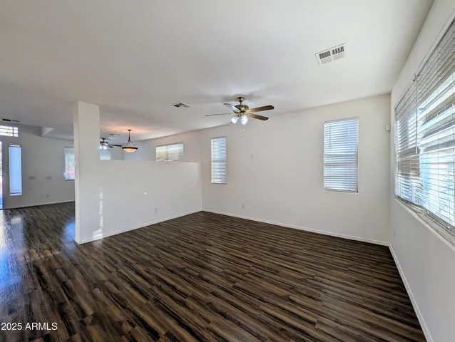 a view of kitchen with granite countertop window and wooden floor