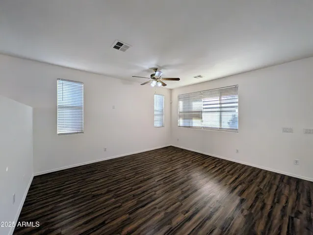 a view of kitchen with wooden floor and a ceiling fan