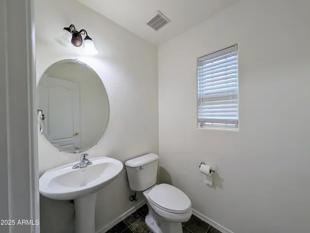a view of a hallway with closet and wooden floor