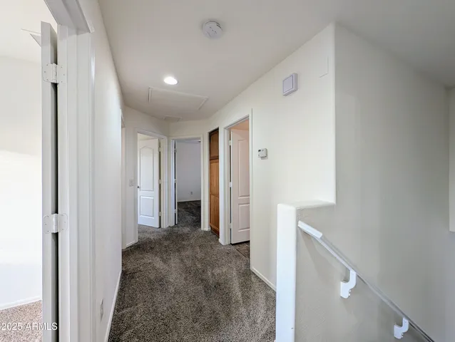 an empty room with fan and windows