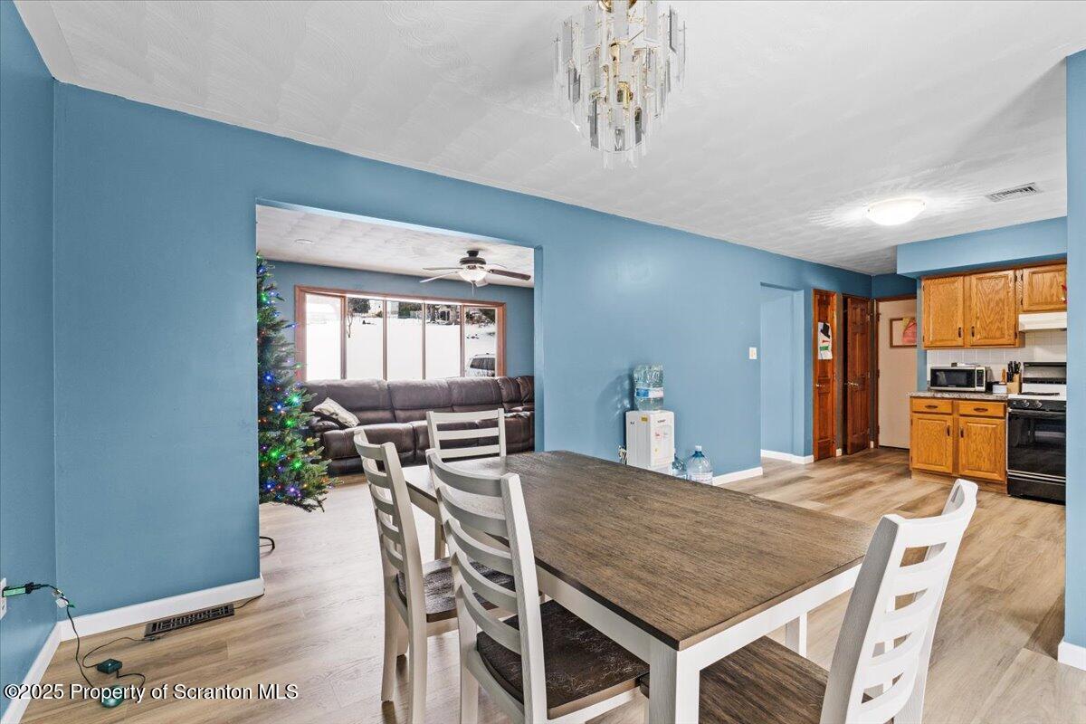 211 New Street Duryea, PA 18642 - Photo 7 of 32 a dining room with a table chairs and kitchen view
