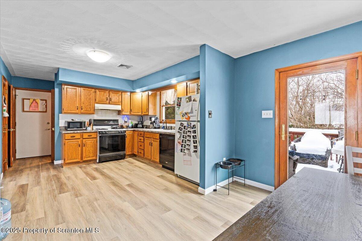 211 New Street Duryea, PA 18642 - Photo 10 of 32 a kitchen with stainless steel appliances kitchen island granite countertop a refrigerator a sink and wooden floors