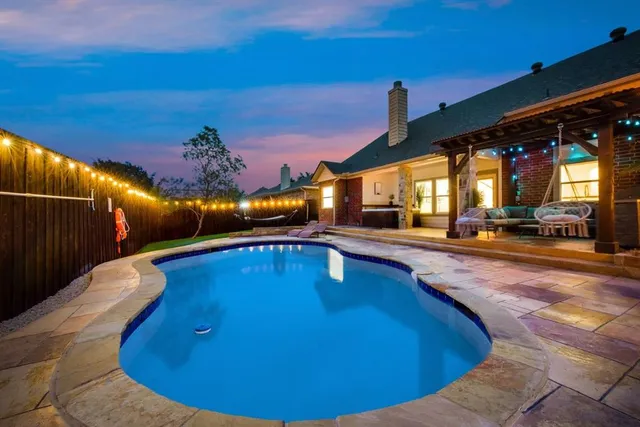 a view of a swimming pool with an outdoor seating