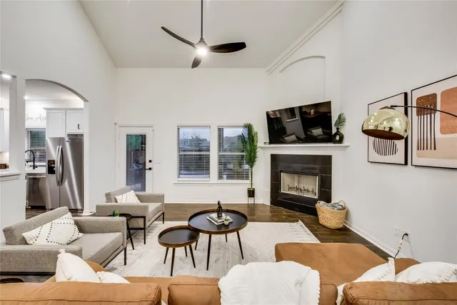 a living room with furniture a fireplace and a flat screen tv