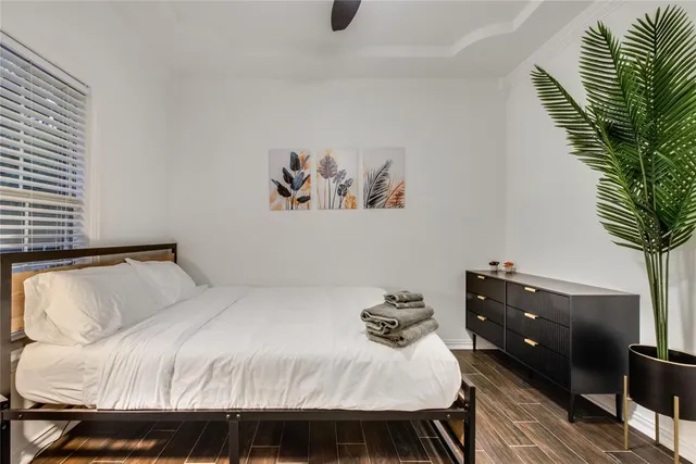 a bedroom with a bed and a potted plant