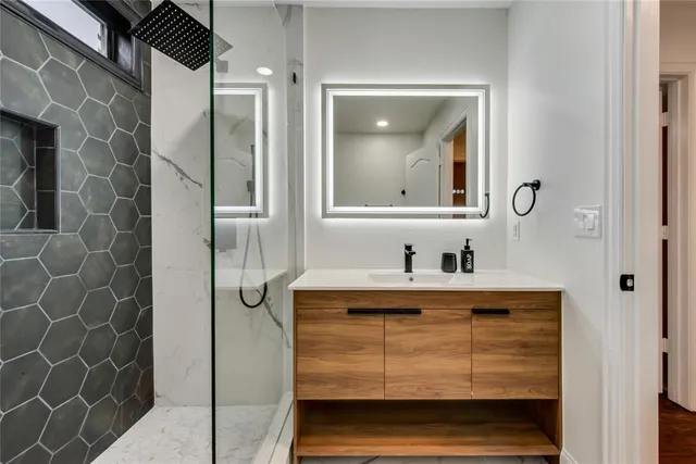 a bathroom with a sink vanity and a mirror