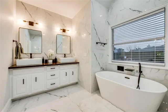 a bathroom with sink bathtub and mirror