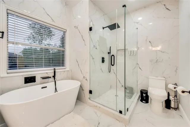 a white bath tub sitting next to a shower