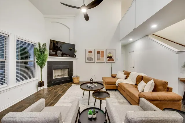 a living room with furniture a fireplace and a flat screen tv