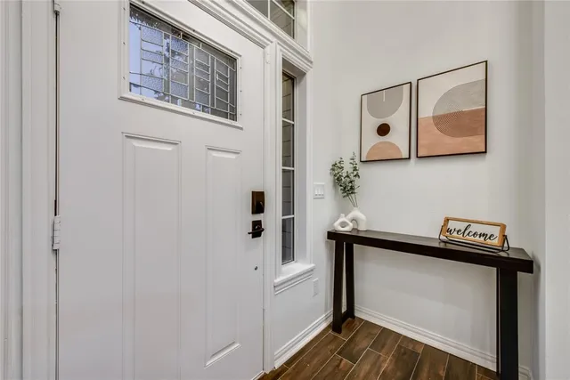 a view of an entryway with wooden floor