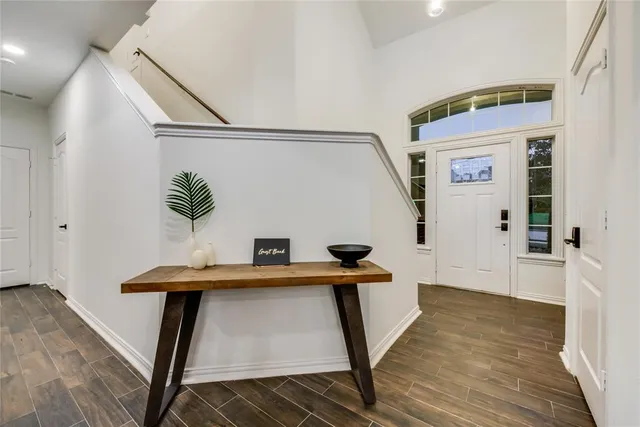 a view of a hallway to a livingroom with furniture wooden floor and hallway