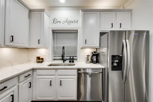 a kitchen with stainless steel appliances granite countertop a refrigerator sink and cabinets