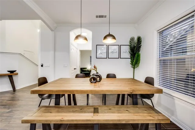 a view of a dining room with furniture and chandelier
