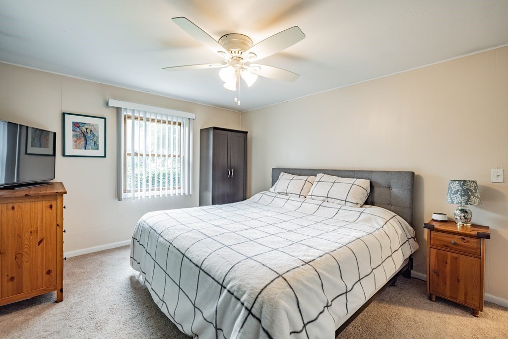 83 Mallowhill Road Springfield, MA 01129 - Photo 17 of 38 a bedroom with a bed and a chandelier
