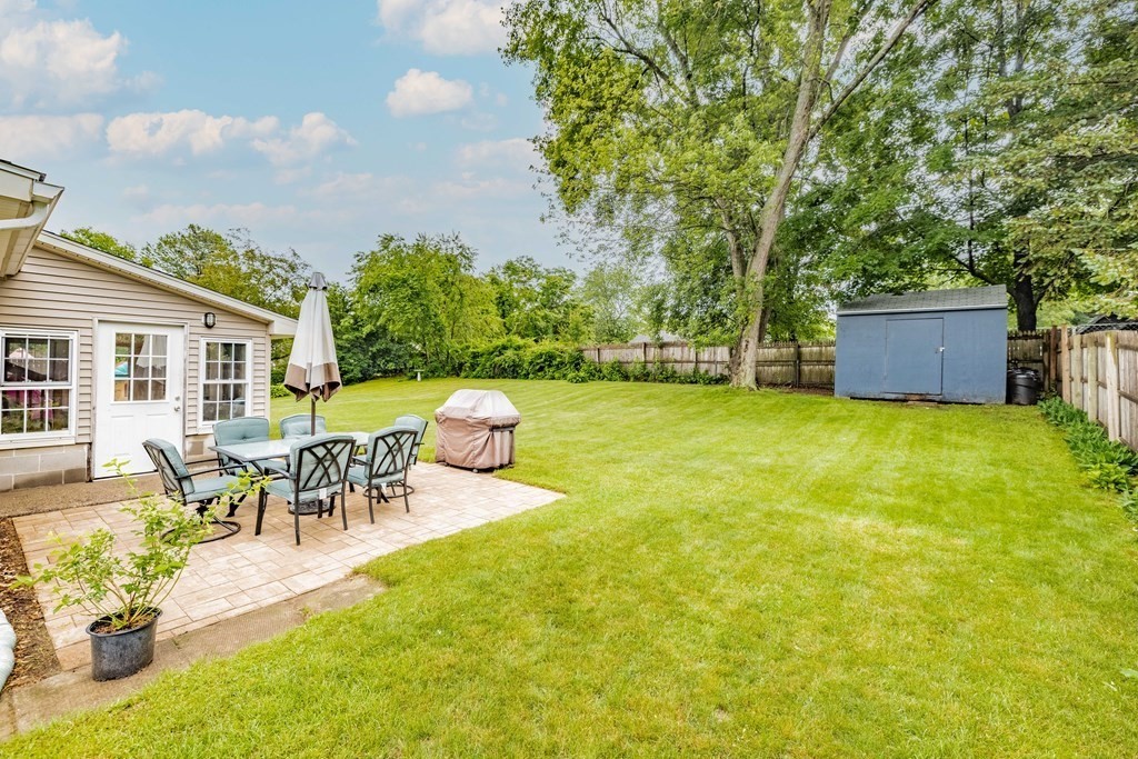 83 Mallowhill Road Springfield, MA 01129 - Photo 32 of 38 a view of a patio with table and chairs and potted plants with wooden fence