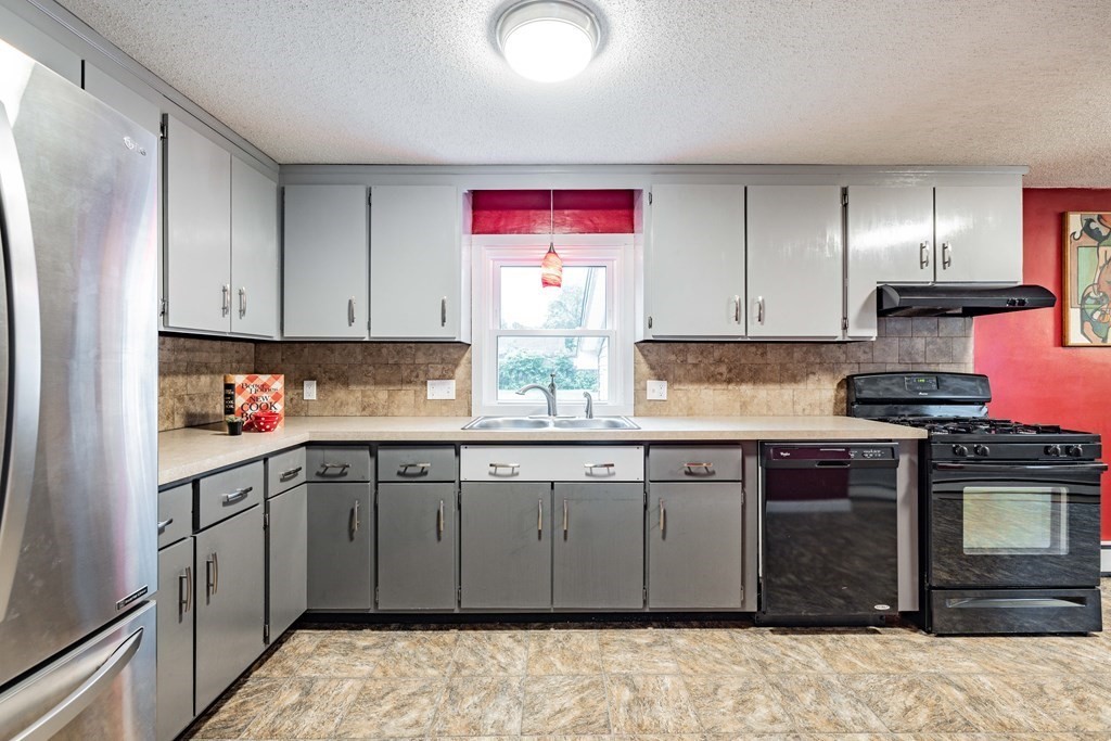83 Mallowhill Road Springfield, MA 01129 - Photo 8 of 38 a kitchen with stainless steel appliances granite countertop a stove sink and cabinets