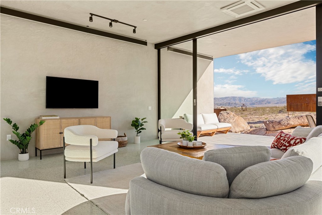 1824 Mountain Shadow Road Joshua Tree, CA 92252 - Photo 11 of 39 a living room with furniture and a flat screen tv