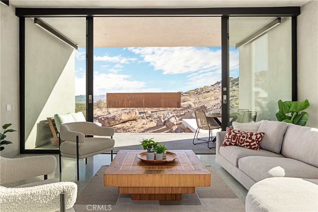 1824 Mountain Shadow Road Joshua Tree, CA 92252 - Photo 12 of 39 a living room with furniture and a large window