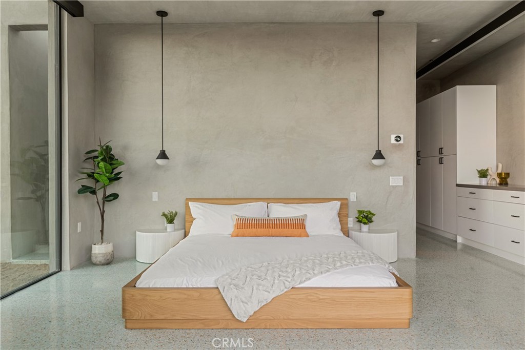 1824 Mountain Shadow Road Joshua Tree, CA 92252 - Photo 16 of 39 a bedroom with a bed and a potted plant