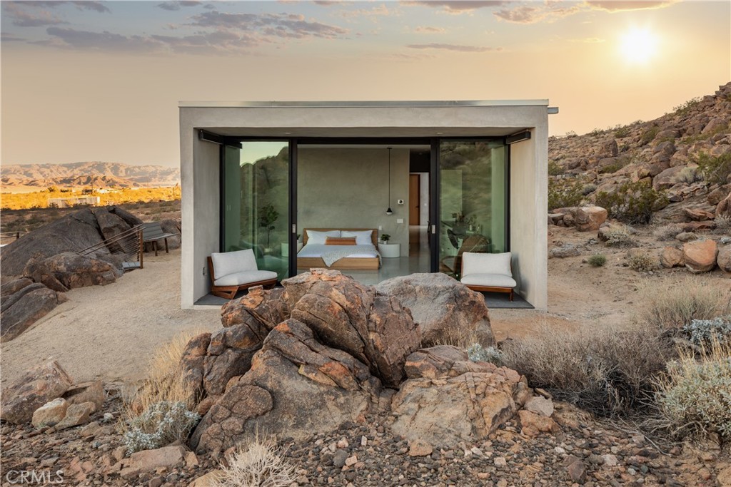1824 Mountain Shadow Road Joshua Tree, CA 92252 - Photo 18 of 39 a bedroom with a bed and large trees