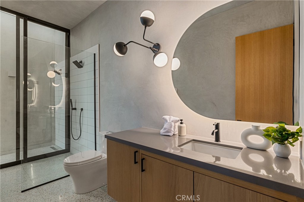 1824 Mountain Shadow Road Joshua Tree, CA 92252 - Photo 19 of 39 a bathroom with a granite countertop sink a toilet a mirror and shower