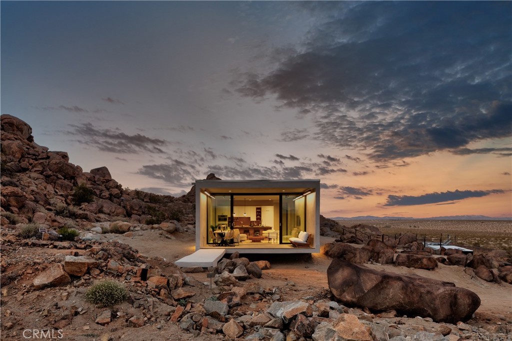 1824 Mountain Shadow Road Joshua Tree, CA 92252 - Photo 2 of 39 a black and white building with trees in the background