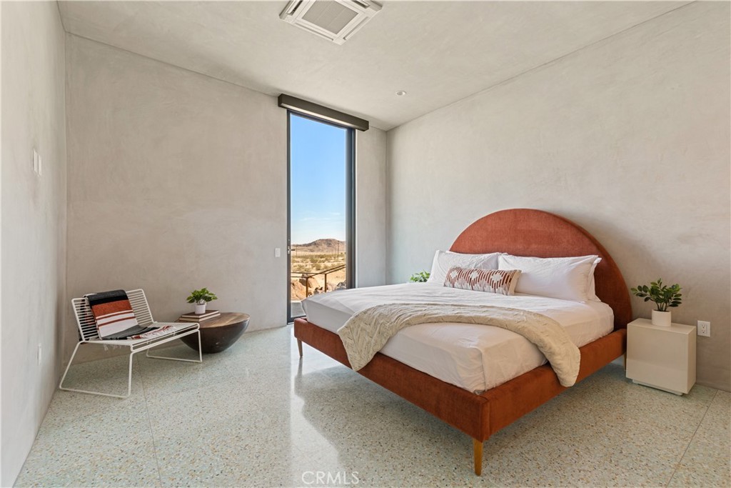 1824 Mountain Shadow Road Joshua Tree, CA 92252 - Photo 22 of 39 a bedroom with a bed and a window