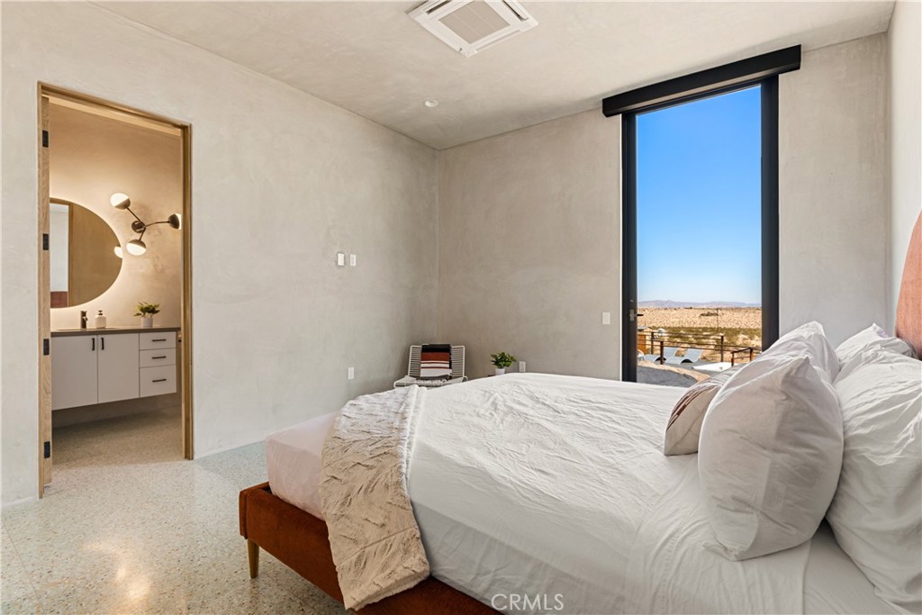 1824 Mountain Shadow Road Joshua Tree, CA 92252 - Photo 23 of 39 a bedroom with a bed and a view of living room
