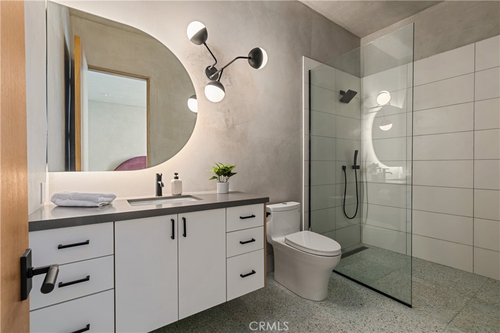 1824 Mountain Shadow Road Joshua Tree, CA 92252 - Photo 25 of 39 a bathroom with a double vanity sink toilet and shower