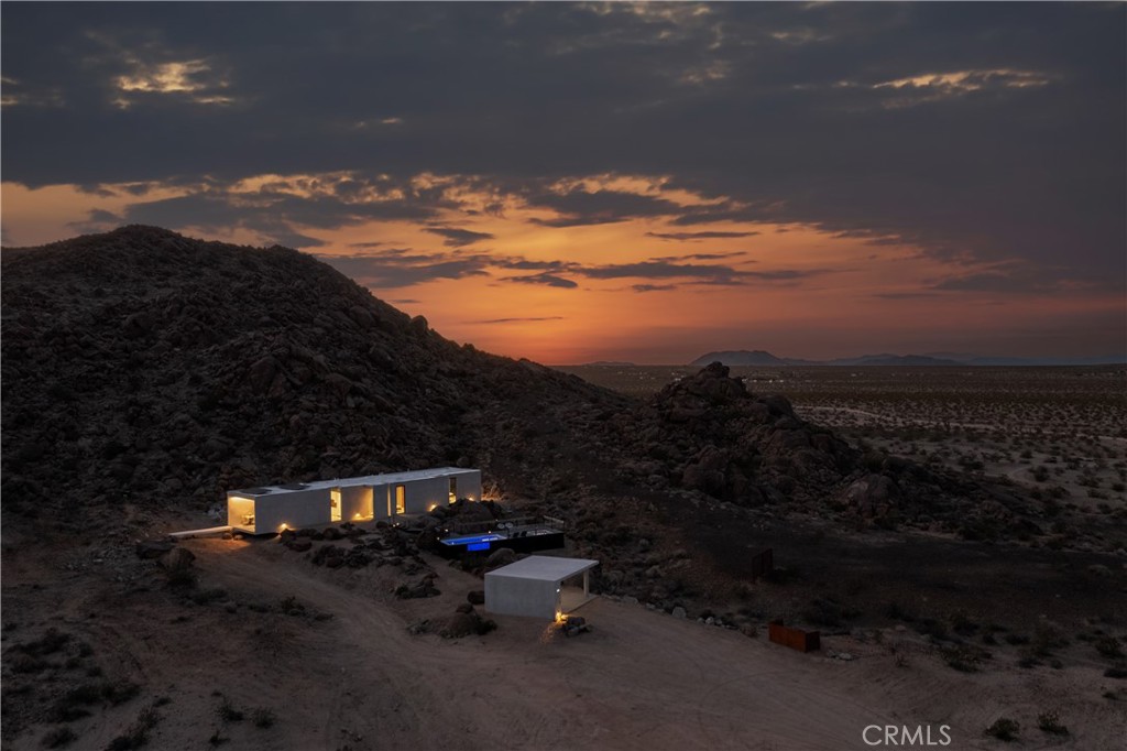 1824 Mountain Shadow Road Joshua Tree, CA 92252 - Photo 39 of 39 a backyard of a house with table and chairs