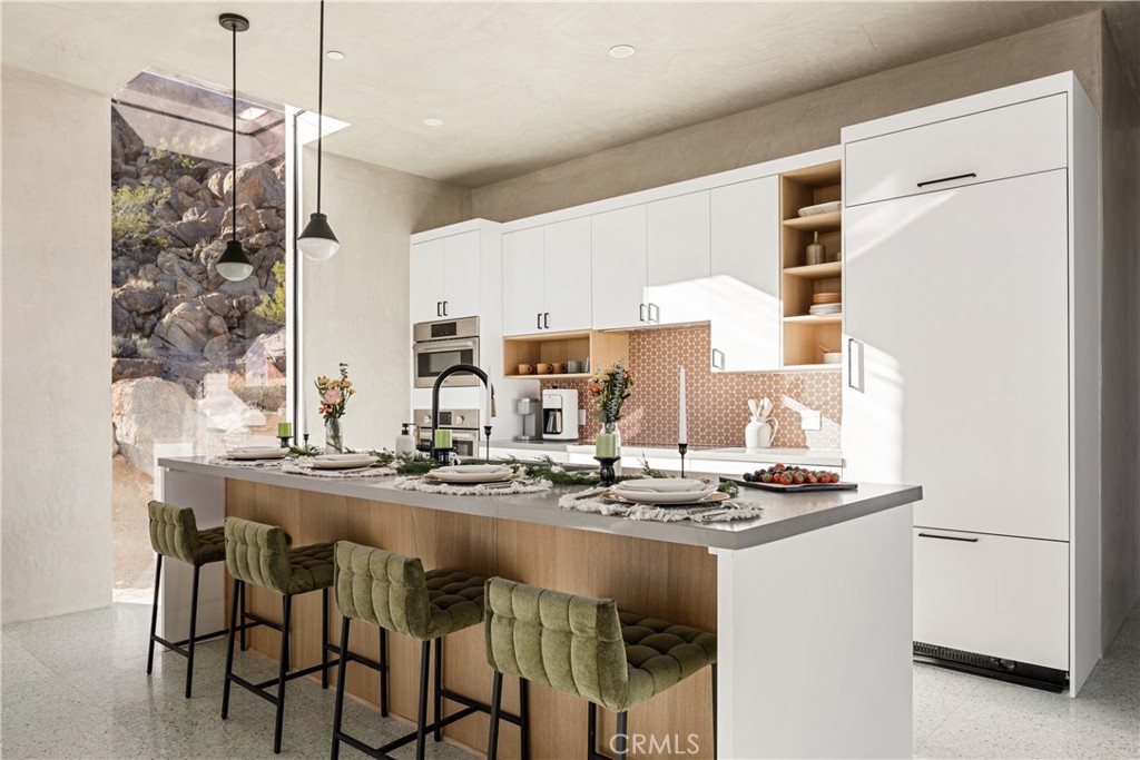 1824 Mountain Shadow Road Joshua Tree, CA 92252 - Photo 6 of 39 a kitchen with stainless steel appliances granite countertop a sink and a stove