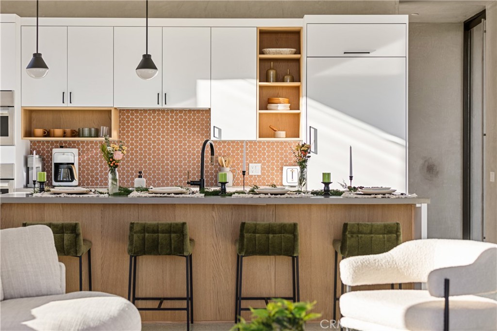 1824 Mountain Shadow Road Joshua Tree, CA 92252 - Photo 7 of 39 a kitchen with a table chairs and a wooden floor
