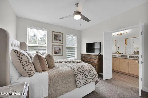 a bedroom with a large bed and a flat screen tv