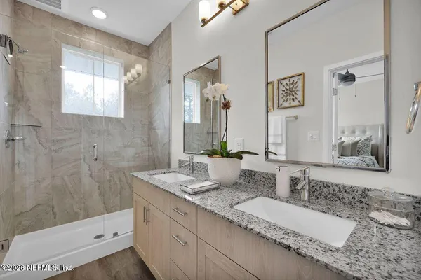 a bathroom with a double vanity sink and a mirror