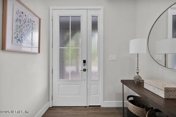 a view of a workspace with furniture and wooden floor