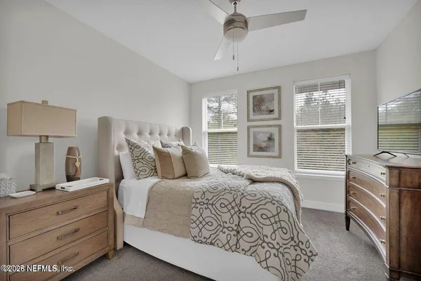 a bedroom with a large bed and a window