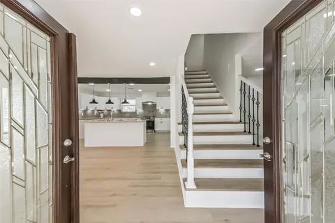 a view of kitchen with livingroom and stairs