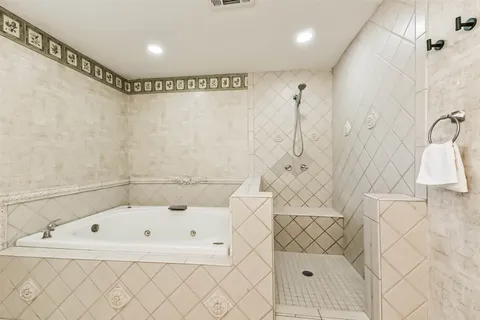a bathroom with a bathtub and shower
