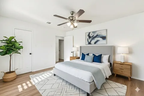 a bedroom with a bed and a painting on the wall