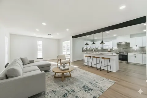 a living room with kitchen island furniture and a wooden floor