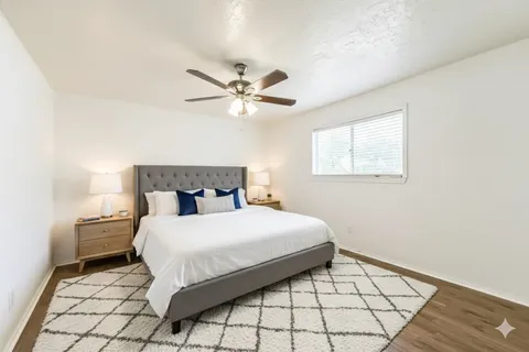 a bedroom with a bed and a window