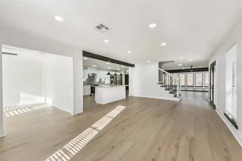 a view of a kitchen with a sink and refrigerator