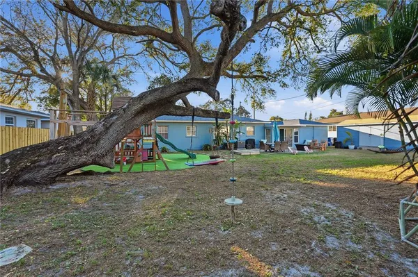 a view of a house with a yard and sitting area