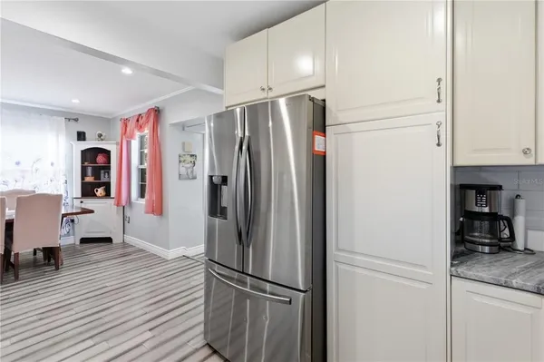 a kitchen with stainless steel appliances granite countertop a refrigerator and a stove top oven