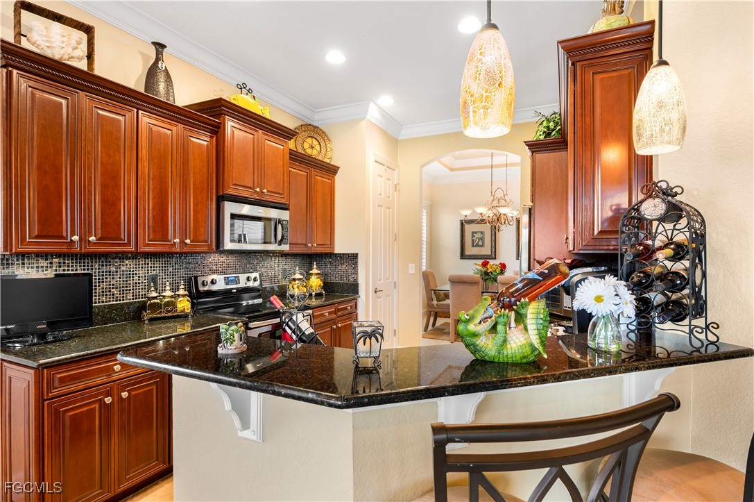 12930 New Market Street, Unit 202 Fort Myers, FL 33913 - Photo 15 of 30 a kitchen with stainless steel appliances granite countertop a sink and a refrigerator
