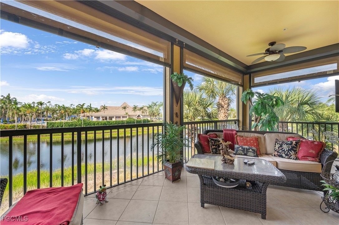 12930 New Market Street, Unit 202 Fort Myers, FL 33913 - Photo 29 of 30 a living room with furniture and a floor to ceiling window
