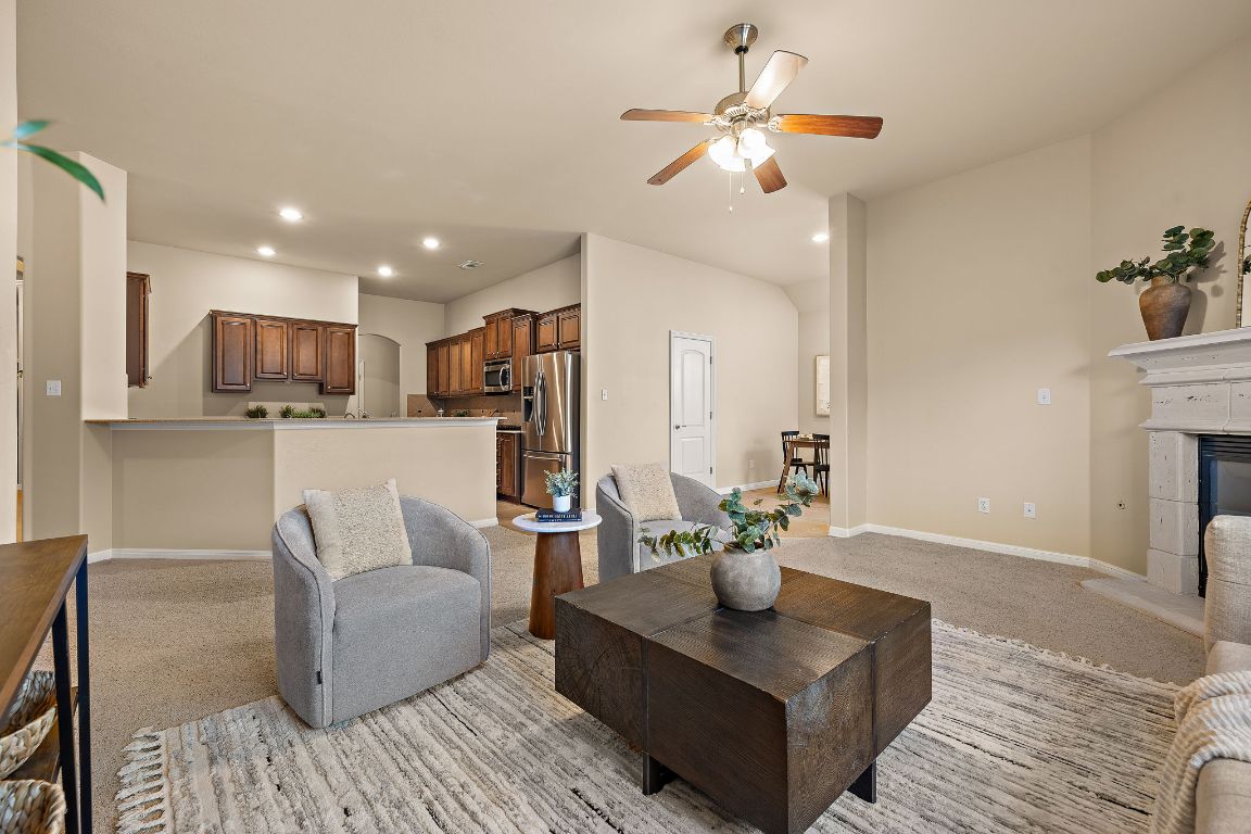 3948 Sapphire Loop Round Rock, TX 78681 - Photo 13 of 40 a living room with furniture kitchen view and a chandelier